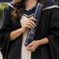 Graduate holding a cranfield university scroll holder 